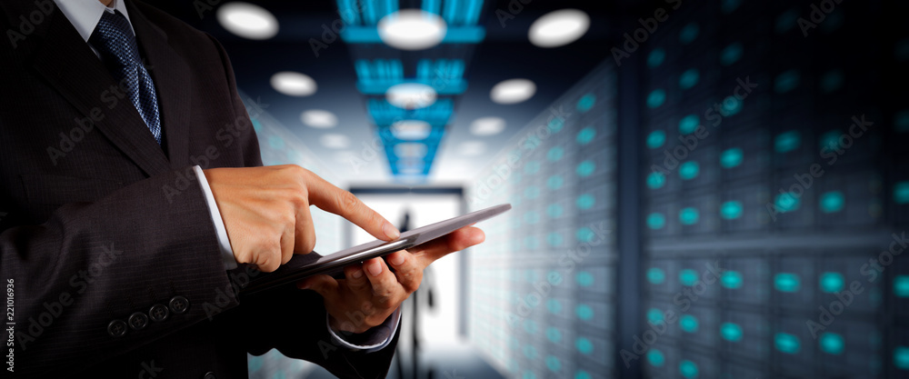 Poster Businessman working with VR wide blank screen computer on server room in background.