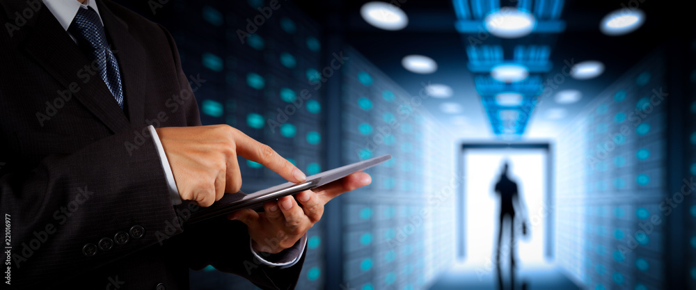 Poster Businessman working with VR wide blank screen computer on server room in background.