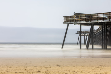 Fototapeta na wymiar A long exposure shot by a pier on Pismo beach