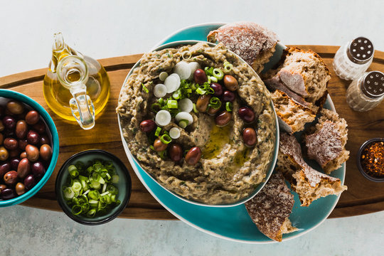 Appetizer with baba ganush of eggplant, olives from kalamata, green onions and fresh rye bread. Mediterranean snack. Vegan healthy food