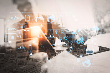 Double exposure of success businessman working in office with digital tablet laptop computer with London building and smart phone,filter effect