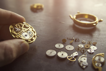 Watchmaker is repairing the mechanical watches in his workshop