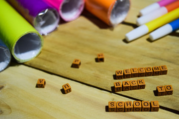 Welcome Back to School on wooden cubes with colorful paper and pen, Concept Inspiration on Wooden background