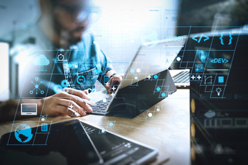 Co working process, entrepreneur team working in creative office space. using digital tablet docking keyboard and laptop with smart phone on marble desk,light beam effect