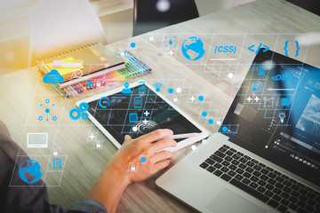 website designer hand attending video conference with laptop computer and smart phone at desk in...