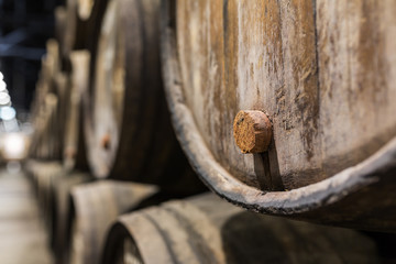 Cork of a wooden porto wine barrel in wine cellar of Porto, Portugal.