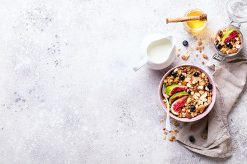 Muesli with Nuts Yogurt and fresh Figs Blueberry on the gray Background.Granola Healthy Breakfast. Sweet food Dessert. Snack  Dry Diet Nutrition Concept.Top View. Flat Lay.Copy space for Text