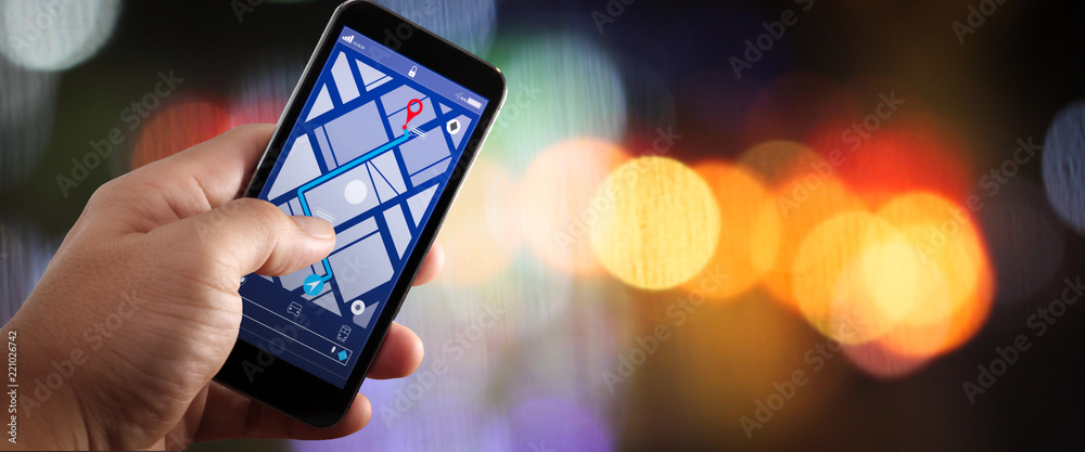 Poster Close up of Tourist using GPS map navigation on smartphone application screen for direction to destination address in the city with travel and technology concept.