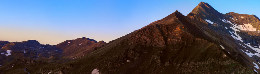 Brennkogel mountain summit with 3018 metres height, as viewed from the Edelweissspitze with tunnels on the left, in the High Tauern at morning