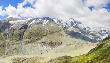 Fototapeta na wymiar Grossglockner Mountain Group with the Sandersee Lake, consisting of declining melt water, from the nine kilometres long Pasterze Glacier with marmots, who are often seen here on the slope