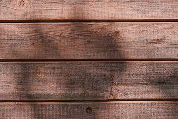 Old brown wooden wall, detailed background photo texture. Wood plank fence close up