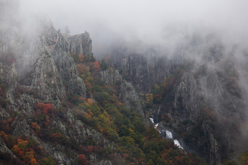 Waterfall in Autumn at the Rhodope mountain range.The mountain is covered with fog