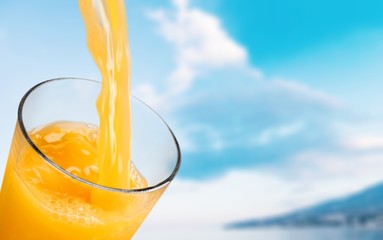 Orange juice glass on background