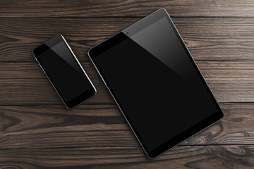 Tablet and smartphone on old wooden background. Top view, flat lay