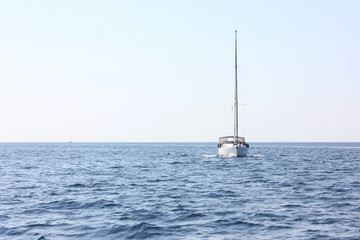 Sail boat on blue water