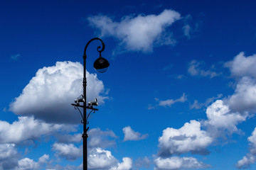 lantern with loudspeaker on the background of clouds