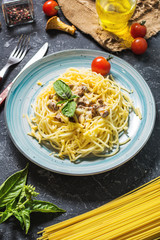 Pasta with chanterelle mushroom and ingredients on a dark stone background