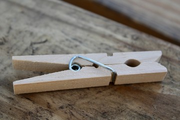 clothespin closeup on a natural wooden background