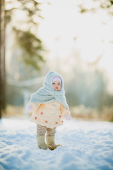 Winter portrait of little girl in fur coat