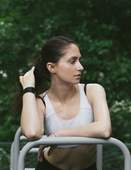 Exercising woman outdoors. Workout of young fit girl in park