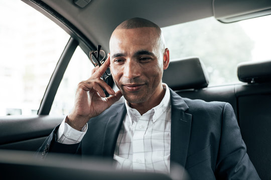 Businessman using laptop sitting in car