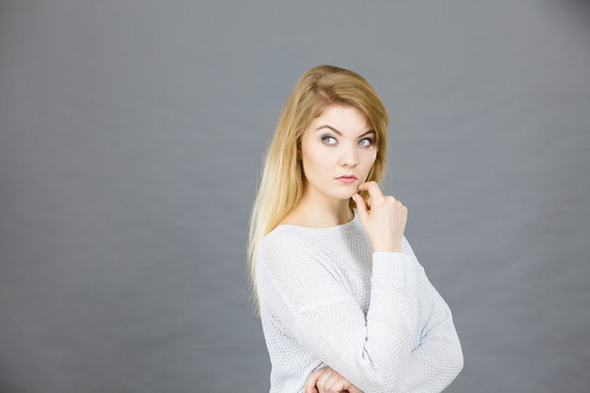 Blonde woman contemplating thinking about something