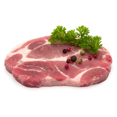Raw pork neck chop meat with parsley herb leaves and peppercorn spices garnish isolated on white background cutout