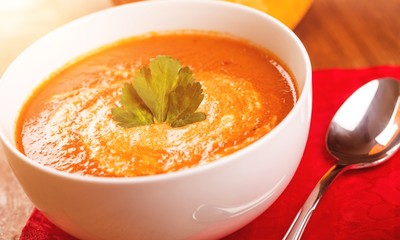 Tasty Pumpkin or  carrot soup on background