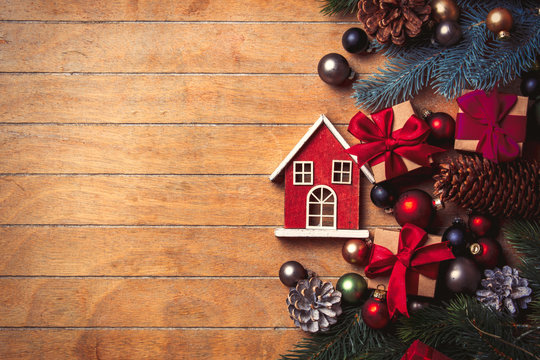 little wooden house and Christmas decoration on wooden table. Above view in old color style