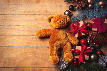 teddy bear with Christmas decoration on wooden table. Above view in old color style
