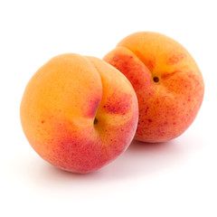 Two apricot fruit isolated on white background cutout