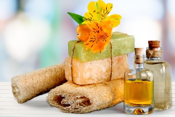 Healthy spa concept with handmade soap bars, oil bottles, sponge