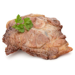 Cooked fried pork meat with parsley herb leaves garnish isolated on white background cutout