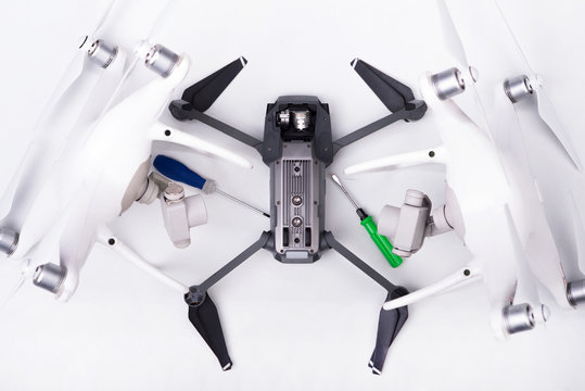 two robot drones repair a black drone