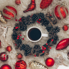 Hot tea and Christmas toys on a warm background of natural warm sheepskins. New Year 2020 composition. Flat lay, top view of New Year 2020 festive still life.