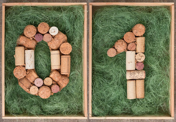 Number 01 zero one made of wine corks on green background in wooden box