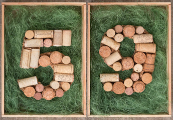 Number 59 fifty nine  made of wine corks on green background in wooden box