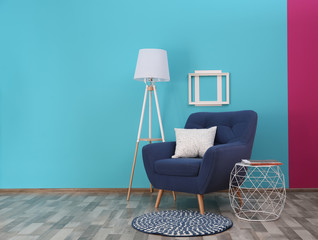 Modern bright interior with comfortable blue armchair