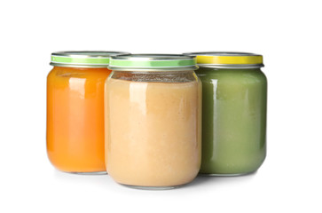 Jars with different baby food on white background