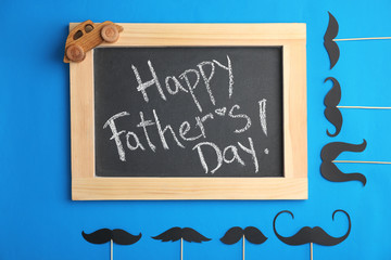 Flat lay composition with blackboard and moustaches on color background. Happy Father's Day
