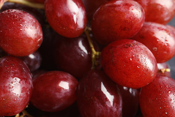 Bunch of red fresh ripe juicy grapes as background. Closeup view