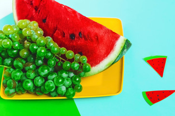 watermelon and grapes on a blue background. autumn food