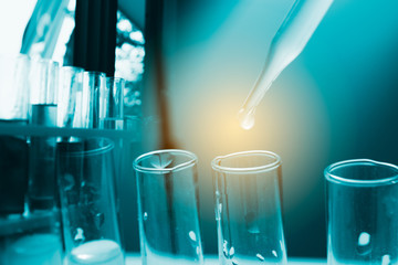 Dropping chemical liquid to test tube, laboratory research and development concept. scientist sample chemistry or medicine test