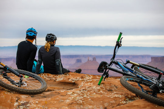 A Young Mountain Biking Couple Takes A Minute To Take In The Scenery 