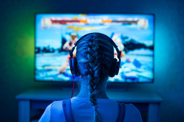 A girl is a gamer or a streamer in front of a television playing.It is possible to use as a...
