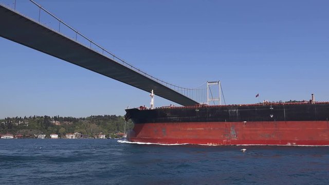Cargo ship sails under the Bosphorus Bridge,  Turkey, Istanbul