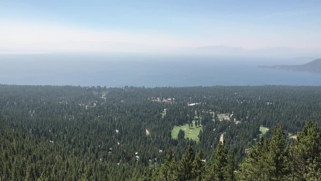 A wide establishing shot of Lake Tahoe, California on a sunny summer day.  	