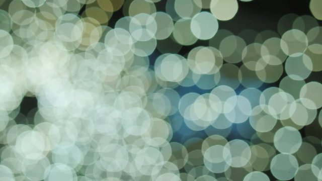 Big white and yellow bokeh background. Yellow defocused circular facula. Natural Floating Organic Abstract Particles On Black Background. Glittering Particles With Bokeh