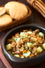 Chilean Estofado or Guiso de Cochayuyo (lat. Durvillaea antarctica) vegan stew of bull kelp, potato, carrot, onion, photographed with natural light (Selective Focus in the middle of the stew)