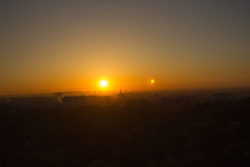 view of the city and the lake at sunset in Almaty